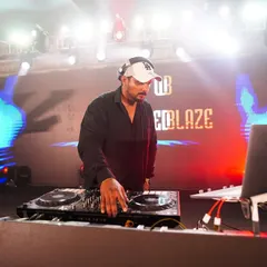 Here I am in my element, locked in on the mix. A professional setup with my "Wicked Blaze" branding means you get a premium audio and visual experience for your event.