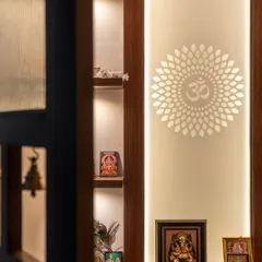 A detail of the puja unit, seen through a custom door with bells that add a gentle, melodious welcome to the sacred space.