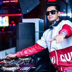 Behind the decks is where I belong. This is a shot of me in my element, focused on the music and the crowd's energy. I bring a professional setup and a stylish presence to every gig.