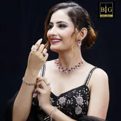 A smiling shot of the model, where the soft updo adds to the overall grace and elegance required for this high-end jewelry advertisement.