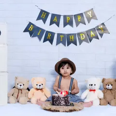 A classic first birthday setup before the smashing begins, featuring a 'Happy Birthday' banner, 'ONE' blocks, and teddy bears.