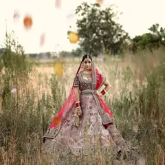 A beautiful outdoor bridal portrait in a field, with a soft, natural light that gives the photo a dreamy quality.