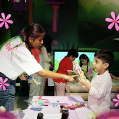 During our Barbie-themed party, every child gets to play and create. A Play Pal is seen here helping a young boy choose a doll for a styling session at our pop-up Barbie Style Studio.