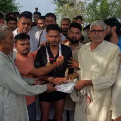 An elder from the village presenting a prize to a winner at the Jaidpura Run. These community events are about more than just running; they are about respect, honor, and local pride.