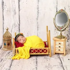 Dreaming in her tiny, elegant bedroom. This setup with a miniature bed and vanity mirror creates a whimsical and precious scene for a sleeping baby girl.