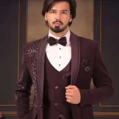 For a sharp reception or party look, we crafted this custom three-piece tuxedo in a rich maroon. Notice the detailed lapel and the perfect fall of the jacket. We make sure every element, from the waistcoat to the bow tie, is stitched to perfection for a modern, confident style.