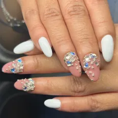 A bold and beautiful set combining crisp white nails with nude accent nails covered in stunning blue and silver 3D rhinestone clusters.