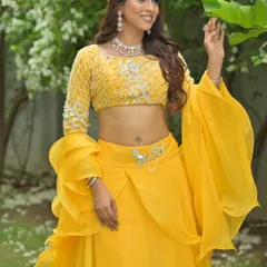 The model interacts with the surrounding nature, showing how this bright yellow outfit stands out beautifully in an outdoor setting.