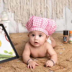 This little chef is melting my heart. The details in this setup, from the gingham hat to the spice rack, create such an adorable and convincing culinary scene.