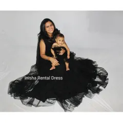 This top-down view shows the beautiful spread of the mother's gown and the adorable matching baby dress. These outfits are perfect for creating artistic and memorable studio photos.