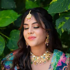 A serene moment with eyes closed, showing off the beautiful eye makeup. This shot highlights the artistry of the makeup artist and the bride's calm happiness.