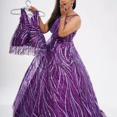 A fun "shooting stars" mother-daughter combo in purple. The sparkling sequence fabric makes this a perfect set for a birthday party or celebration.