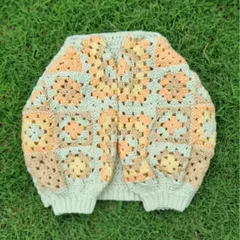 A flat-lay view of the granny tee, showing the construction and the pattern of the granny square sleeves. This top combines two different crochet techniques to create a really unique and stylish piece.