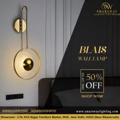 The Blais Wall Lamp is a beautiful and elegant piece with a textured glass disc and a gold finish. It's a perfect accent light for a sophisticated bedroom or living room.