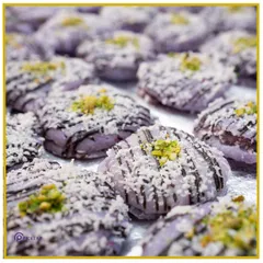 Indulge in our handcrafted Jamun Macaroons. This fusion dessert combines the classic Indian sweet with a French patisserie technique, topped with coconut and pistachio.