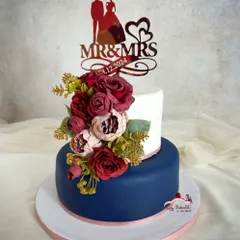 A simple yet elegant wedding cake in burgundy, navy blue, and rose gold. This was a rich plum cake covered in marzipan and fondant.