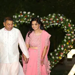 A beautiful, candid moment from the 25th-anniversary celebration, with my floral heart backdrop adding to the romance of the occasion.