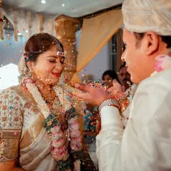 A candid moment of joy during the talambralu ritual. Capturing the genuine smiles and flying grains makes for a dynamic and happy memory.