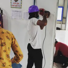 Our technician uses professional tools to drill and prepare the wall for mounting the access control device. Proper mounting is critical for the stability and durability of any security hardware, and we ensure it's done right.