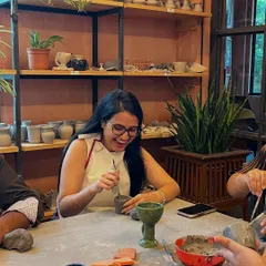 The pure joy of creating something with your own hands. This moment of laughter from one of our hand-building workshops captures the relaxed, fun atmosphere we foster, where the process is just as important as the final piece.
