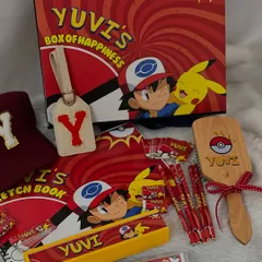 Gotta catch 'em all! This personalized Pokémon-themed stationery set is perfect for a little trainer. It includes a custom box, sketchbook, pencils, hairbrush, and luggage tag, all featuring Pikachu and Ash.
