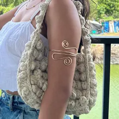 A lifestyle shot of my crochet puff bag. The textured design and neutral color make it a versatile accessory that complements any casual outfit.