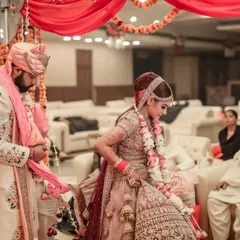 Capturing the Gathbandhan ritual during the wedding ceremony, where the couple's garments are tied together, symbolizing their sacred union.
