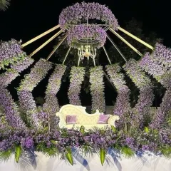 For a truly unique reception, we designed this royal crown-inspired stage. The structure is made of arches densely packed with purple flowers, with a beautiful chandelier at the center. It’s a bold and unforgettable backdrop that will make you feel like royalty on your special day.