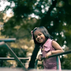 A tighter crop of a similar candid moment. The genuine smile is what makes a children's portrait truly special and timeless.