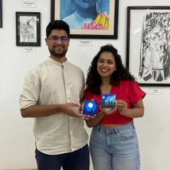A couple proudly holds up the miniature canvas paintings they created. My workshops are a great way to spend quality time and do something different.
