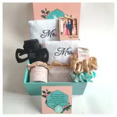 A beautiful anniversary gift box for the perfect pair. This hamper includes embroidered 'Mr' and 'Mrs' towels, a personalized photo frame, a scented candle, and matching accessories for him and her.