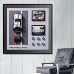 For the Porsche lover, this shadow box is the ultimate tribute. It features a miniature Porsche model, a controller, and framed pictures, all arranged in a sleek design that celebrates the legacy of speed and style.