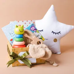 A different angle of our newborn gift hamper, showing the cute star pillow that makes a lovely addition to any nursery.