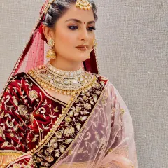 For this bride, we chose a regal look with a deep velvet lehenga. I created a soft but defined smokey eye and a neutral matte lip to balance the richness of her outfit, along with a braided updo to secure her dupatta.