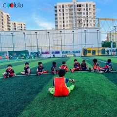 A group of young athletes led by a coach in pre-game stretches. This disciplined approach ensures every player is physically prepared for the session ahead.