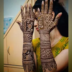 A beautiful and dense back-hand mehandi design. The patterns are a mix of traditional motifs that create a rich and elegant look.