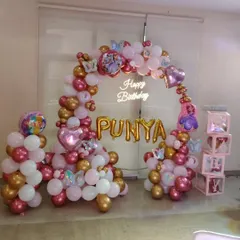Another angle of the "PUNYA" birthday setup, showing the full balloon arch and personalized elements.