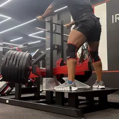 This image shows me performing a pendulum squat, part of a high volume leg day. The full workout included single leg extensions, Bulgarian split squats, and belt squats up to 280kg. I provide these detailed workout splits to my mentees to build their programming library.