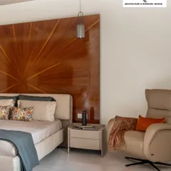 Craftsmanship is at the heart of my designs. This master bedroom features a magnificent radial wooden headboard that acts as a stunning centerpiece, radiating warmth and sophistication. It’s a personal sanctuary designed for rest and rejuvenation.