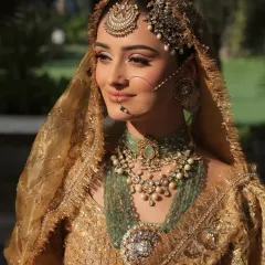 A close-up on the exquisite craftsmanship of the bridal jewelry. The layered necklaces and the intricate nath (nose ring) are central to creating this majestic and timeless bridal look.