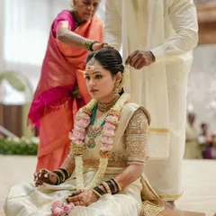 Our lovely bride Harshitha during her Muhurtham ceremony. She looks serene and beautiful in a traditional off-white Kanjivaram saree paired with a custom-designed embroidered blouse.