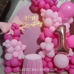 A view of the first birthday setup with a golden acrylic 'Happy Birthday' sign, offering a different signage option from neon.