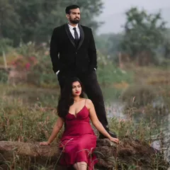 A powerful, poised portrait by the water. This shot has a cinematic feel, using the natural landscape to create a dramatic and romantic mood for this outdoor couple shoot.