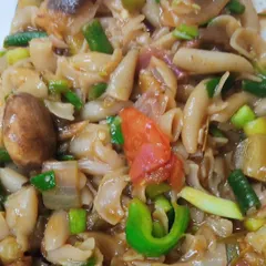 I cooked this Little Millet Macaroni pasta, and it was a delight. The pasta itself is from Organic Bharat, and I cooked it with a mix of vegetables from our farmers: beans, mushrooms, leeks, eggplants, and tomatoes. It's a perfect example of how you can create a healthy, delicious, and dairy-free meal using ingredients from the market.
