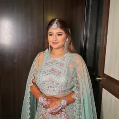 Riddhi looks absolutely beautiful and ready for her mehendi ceremony. The makeup is fresh and bright, perfect for a daytime event.