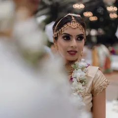 This candid moment from a Muhurtham ceremony captures the beauty of a dramatic smokey eye paired with a subtle, glowing base. It's a look that is both traditional and modern, perfect for the bride who wants her eyes to do the talking.
