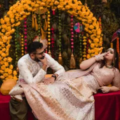 I love capturing the playful side of a couple's love story. Here, during a vibrant Kashmiri 'Saath Mainz' ceremony, the bride playfully teases her groom against a backdrop of marigold decor. It’s these unposed, candid moments that truly show a couple's unique chemistry.