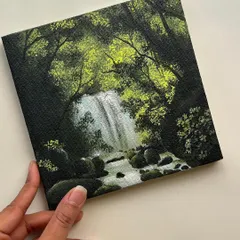 Holding my finished mini waterfall painting. This small canvas captures the feeling of being lost in the woods, surrounded by the sounds of nature.