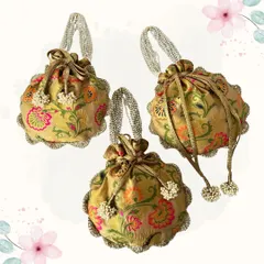A beautiful brocade potli with a pearl handle and delicate floral design. This is a classic and elegant accessory, perfect for a bride or wedding guest.