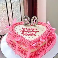 Our vintage heart cakes are one of our most requested styles. This beauty, for a 20th birthday, features layers of delicate pink ruffles, intricate piping, and pretty satin bows. It’s a classic chocolate truffle cake that tastes as dreamy as it looks.